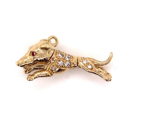 A YELLOW PRECIOUS METAL, ASSESSED AS FINENESS 375, ARTICULATED DOG PENDANT, INSET WITH RUBY EYES AND A PART CUBIC ZIRCONIA BO