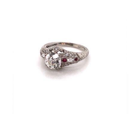 A PLATINUM HALLMARKED DIAMOND AND RUBY RING. THE PRINCIPAL DIAMOND AN OLD CUT IN A RAISED DOUBLE FOUR CLAW SETTING UPON  FANC