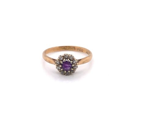 AN ANTIQUE 9ct STAMPED AMETHYST AND DIAMOND CLUSTER RING. FINGER SIZE O. WEIGHT 2grms. 