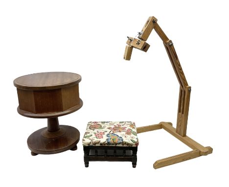 Oak sewing stool on a pedestal base with a hinged lid and compartmented interior, together with an upholstered footstool and 