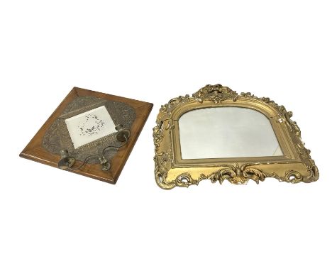 Wall mounted mirror with brass repoussé decoration above twin branched candlesticks, L57cm, together with a further gilt mirr