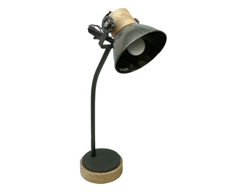 Adjustable table lamp, in green matt finish upon a circular wooden plinth, H64cm 