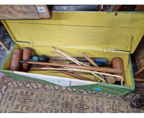 A CROQUET SET IN A PAINTED WOODEN BOX TOGETHER WITH OTHER MALLETS AND A HOCKEY STICK