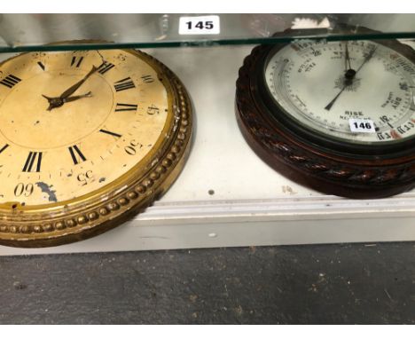 AN OAK CASED ANEROID BAROMETER TOGETHER WITH A GILT FRAMED CLOCK FACE