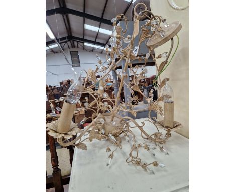 A THREE LIGHT CHANDELIER WITH GLASS TORPEDO DROPS HELD IN MUSHROOM WIRE WORK AMONGST LEAVES