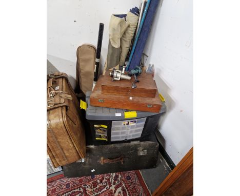 FISHING EQUIPMENT, A SUITCASE AND A CAR TRUNK