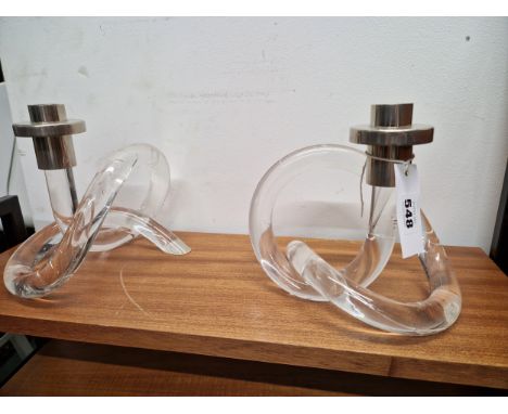 A PAIR OF CANDLESTICK WITH CHROMED NOZZLES SUPPORTED ON KNOTTED CYLINDRICAL CLEAR PLASTIC BASES 