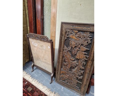 AN ORIENTAL CARVED HARDWOOD PANEL AND AN OAK FIRE SCREEN.