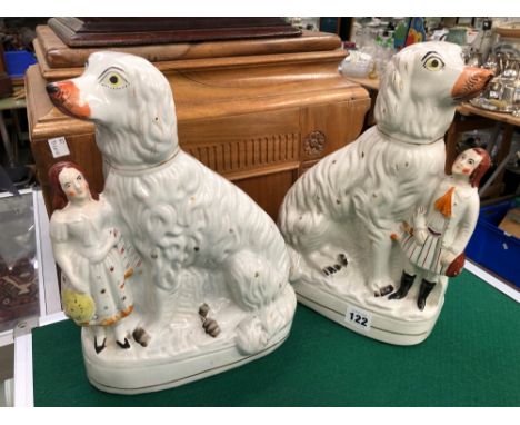 A RARE PAIR OF STAFFORDSHIRE SPANIELS WITH FIGURES.