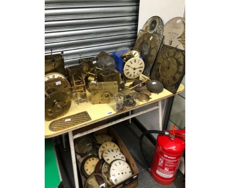 A COLLECTION OF CLOCK MOVEMENTS, FACES AND PARTS