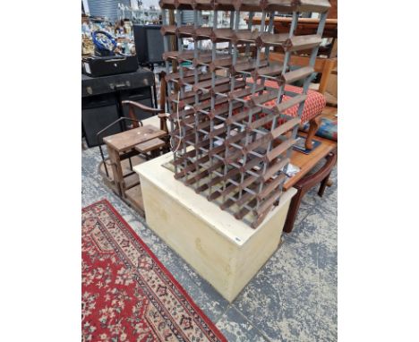 A PAINTED BLANKET BOX. 55 X 90 X 58CMS, A WINE RACK A BRASS STANDARD LAMP AND A STOOL.