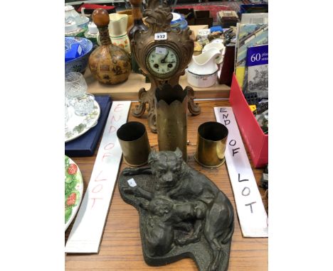 A SPELTER CASED CLOCK, THREE TRENCH ART SHELL CASES AND A COLD CAST MOTHER SUCKLING TWO PUPPIES