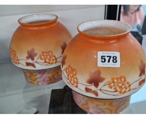 A PAIR OF FROSTED MILK GLASS LIGHT SHADES WITH ORANGE DECORATION