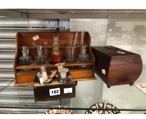 A COLLECTION OF CHEMISTRY BOTTLES IN TWO WOOD STANDS TOGETHER WITH A MAHOGANY TEA CADDY
