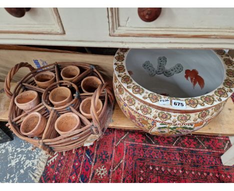 AN ORIENTAL PLANTER TOGETHER WITH A BASKET OF 8 TERRACOTTA FLOWER POTS