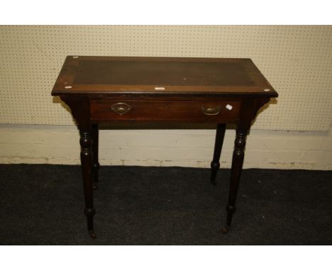 An Edwardian mahogany lady's writing table, the hide scriber set rectangular top over a single frieze drawer, on baluster tur