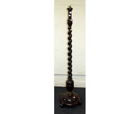 An early 20th century standard lamp with barley twist column on domed circular plinth and scroll feet. 152cm