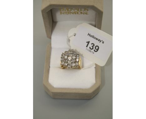 A large diamond cluster ring, comprising five vertical bands of brilliant cut diamonds in raised claw mounts, overall weight 