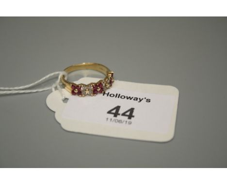 A ruby and diamond half hoop flowerhead cluster ring in 18ct gold mount 2.33g