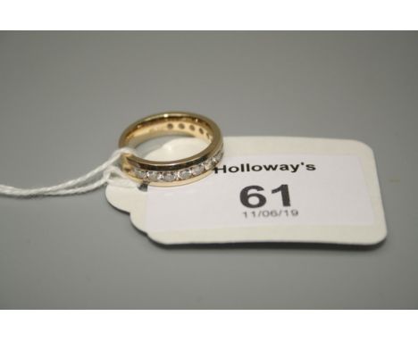A diamond set eternity ring, the three quarter hoop ring channel set with brilliant cut diamonds, 4.4g