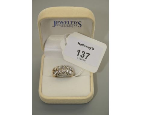 A two row, ten stone half hoop diamond ring, the brilliant cut diamonds in carved claw mounts to reeded shoulders, Size L