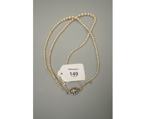 A two row graduated cultured pearl necklace, to a cultured pearl and paste cluster clasp, 40cm length