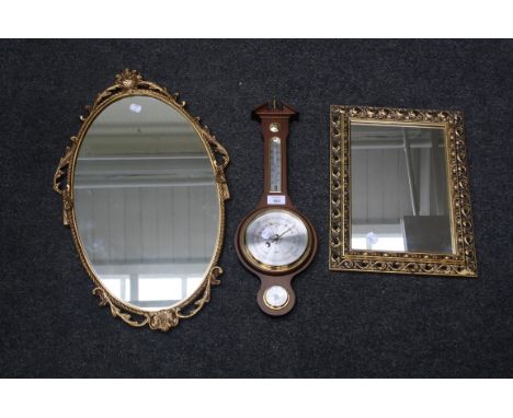A reproduction German wheel barometer and two gilt framed wall mirrors