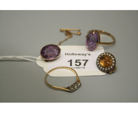 A single stone oval amethyst brooch in collet mount, a single stone amethyst ring, a three stone diamond ring , a seed pearl 