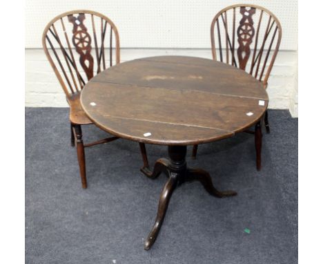 A George III oak tripod table with circular tilt top, together with a pair of 19th century beech and elm wheel and stick back