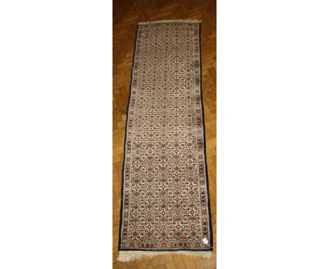 A 20th century wool runner, woven with trellised floral forms on a blue/cream background. 280 x 80cm