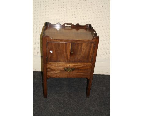 A George III mahogany tray top night commode, with pierced handles over a pair of cupboard doors and drawer seat with hide co