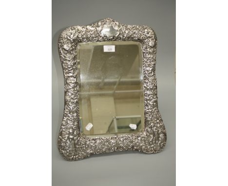 Probably William Comyns, a large early 19th century silver framed easel dressing mirror, richly decorated with a courting cou