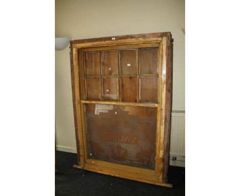 An Edwardian pine framed pub saloon sash window, the primary pane etched ' Vaults' within a leafy border. 175 x 140cm (total)
