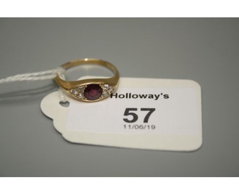 A late Victorian seven stone half hoop ruby and diamond ring, the central circular cut ruby with three stone diamond detail t