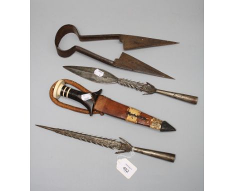 Two African barbed iron spearheads, 34 and 36cm, together with a khanjar type dagger, an ivory and horn banded wood handled d