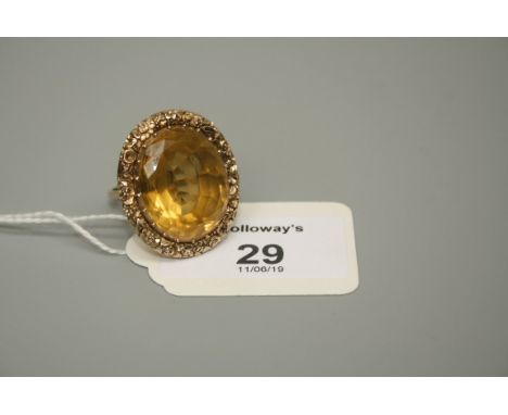 A substantial single stone citrine dress ring, the oval cut stone in foliate carved surround to basket mount and plain shank