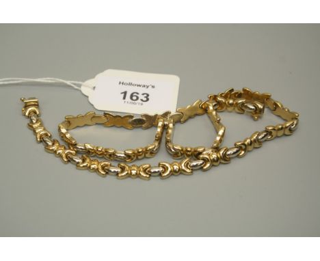 A bi-coloured necklace of fancy bow design with oval spacers to concealed push button clasp, stamped Italy 750, 27.6g