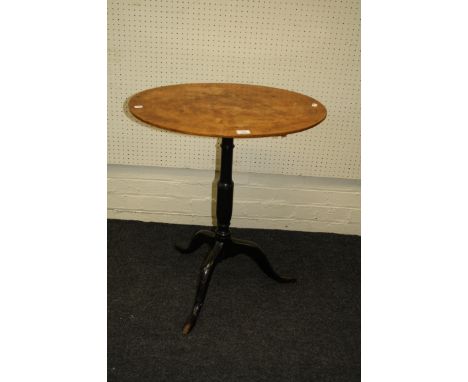 A basically 19th century tripod table having an oval burr walnut top on an ebonized column and three downswept legs. 74 x 65c