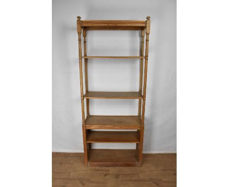 Set of oak shelves, with four shelves between turned gun barrel supports, 85cm wide x 35cm deep x 225cm high