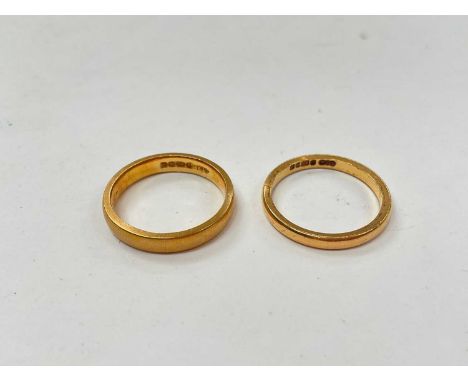 Two 22ct gold wedding rings, thicker band (Birmingham 1926), the other (Birmingham 1951), both size K½Total weight 7.3 grams.