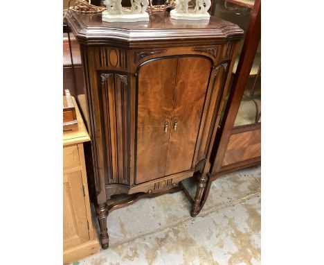 Mahogany cabinet with two doors on fluted turned supports joined by stretchers, 67cm wide, 46cm deep, 125cm high