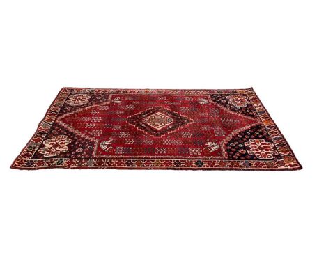Eastern rug with central medallion on red and blue ground, 240cm x 152cm