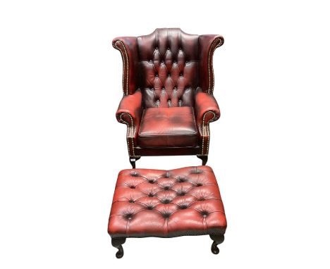 Georgian style oxblood leather wing back armchair and matching footstool (2)good condition with 'Antiqued ' finish to the lea