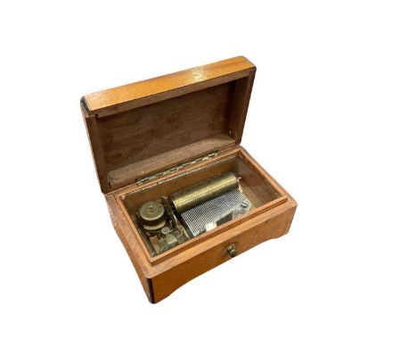 Small oak cased music box.The Music box is not currently running and it does not wind properly