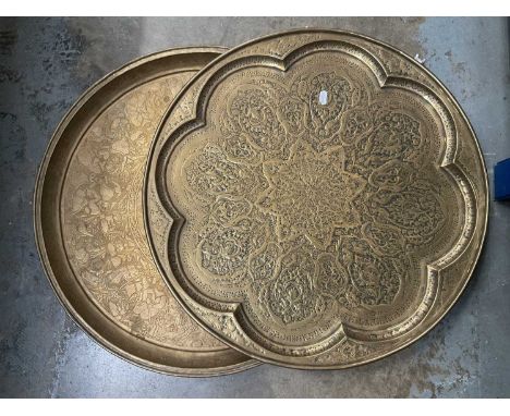Two large Persian embossed brass chargers, each approximately 58cm diameter