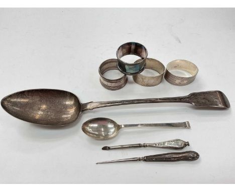Four silver napkins rings, silver teaspoon, white metal serving spoon and two silver handled items