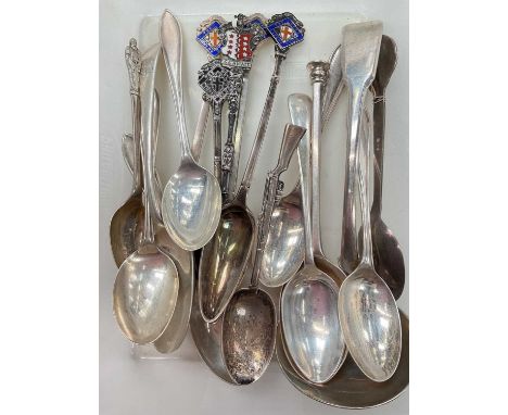 Collection of silver and white metal spoons including some enamelled souvenir spoons and a spoon in the form of an air rifleT