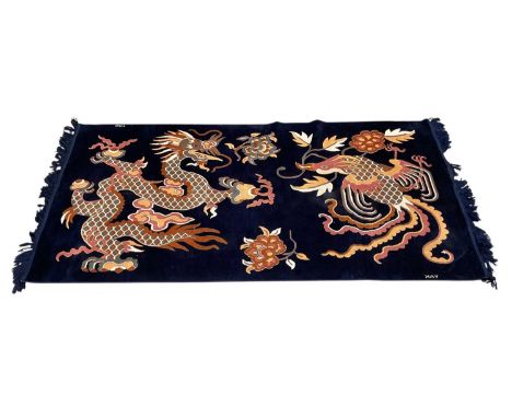 Chinese dragon and phoenix rug on blue ground signed 'YAK', 180 x 90cm