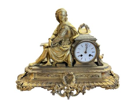 19th century French gilt metal figural mantel clock, asymmetric form with figural surmount emblematic of the arts, circular e