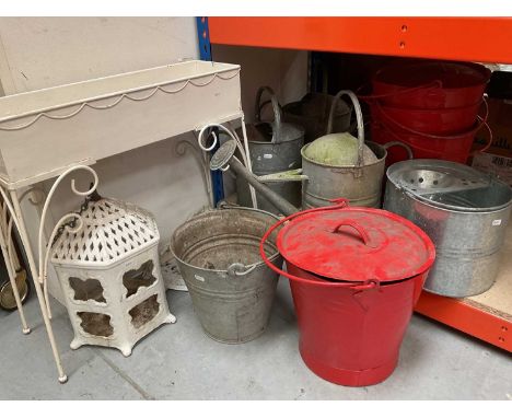 Group of watering cans, red painted fire buckets, cream painted planter on stand and other items